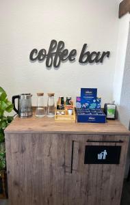 eine Kaffeebar mit einem Schild an der Wand in der Unterkunft Pension Holter Deel in Cuxhaven