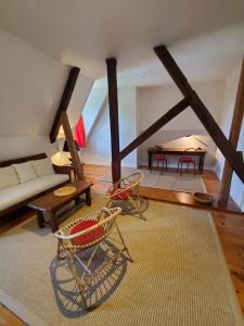 a living room with a couch and a table at Logis des Tourelles Appartement in Cognac +12 photos