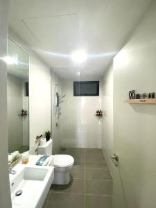 a white bathroom with a toilet and a sink at MidValley SouthKey Mosaic Tower B in Johor Bahru