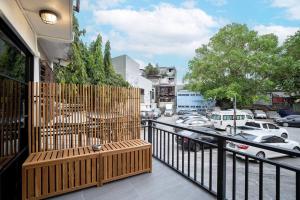 a balcony with a wooden fence and a parking lot at Townhouse in Pratunam Bangkok in Bangkok