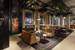 a restaurant with chairs and tables and a bar at EDIT Lofts in Turin