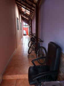 een fiets geparkeerd in een gang met een stoel bij Alojamento do João in Lagoa Santa