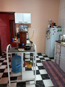een keuken met een zwart-wit geruite vloer bij Alojamento do João in Lagoa Santa