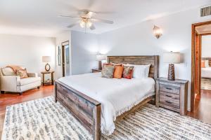 a bedroom with a large bed and a couch at Sundance in the Foothills in Tucson