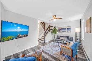 a living room with a tv on a wall at Modern & Quant KOP 3 Bed/1 ba in King of Prussia