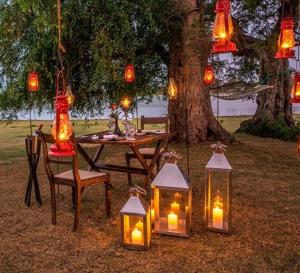 a group of lanterns on the ground next to a table at kenuson yala in Tissamaharama