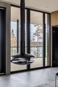 a black stove in a living room with windows at Luxury Holiday Villa Lake Pavillion in Turenki