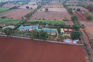 an aerial view of a house in a field at KRISHNA HERITAGE RESORT in Badami