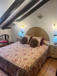 a bedroom with a bed with two pillows on it at Hotel El Bricial in Soto de Cangas