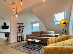 a living room with a couch and a table at VonMos Loft Apartment in Bernkastel-Kues