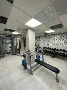 a gym with a bench and equipment in a room at HAVANA HOTEL in Kemer