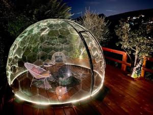 una cúpula de cristal en una terraza con mesas y sillas en @LaCasettasulFiume, en Sarnico