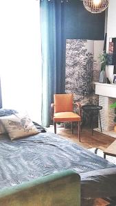 1 dormitorio con 1 cama y 1 silla en Appartement une chambre avec balcon, en Chambly