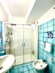 a bathroom with a shower and a sink and a toilet at Hotel Le Fioriere in Praiano