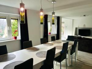 a dining room with a table and chairs at Ferienhaus Wachwitzgrund in Dresden