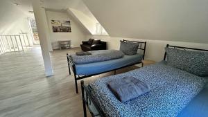 a bedroom with two beds and a living room at Ferienhaus Wachwitzgrund in Dresden