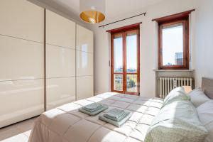 a bedroom with a bed with two pillows on it at San Luigi Apartment 3.0 in Beinasco
