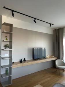 a living room with a tv on a wall at Apartment ALPHA in Banja Luka