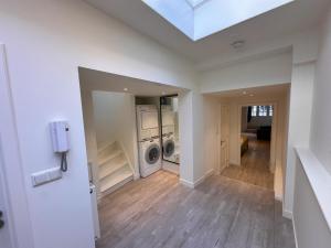 a laundry room with a washer and dryer in a house at Tulip House Luxury Apartment - Top Location - Rijksmuseum - Leidseplein AMSTERDAM Central 120 m2 ALL Private with kitchen in Amsterdam +31 photos