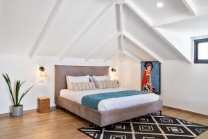 a bedroom with a bed in a attic at Valley Suites in Luzit