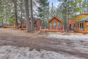 a group of log homes in the woods at Cozy and Restful Cabin, Steps to Lake Almanor in Lake Almanor