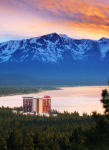 a view of a hotel with snow capped mountains in the background at Bally's Lake Tahoe Casino Resort in Stateline