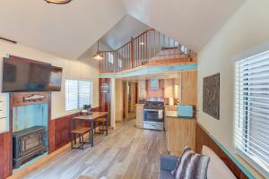 a large living room with a staircase and a kitchen at Quiet Lake Almanor Cabin, Steps to Fishing in Lake Almanor