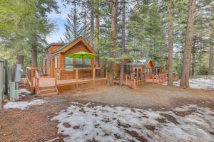 a log cabin with a playground in the woods at Quiet Lake Almanor Cabin, Steps to Fishing in Lake Almanor
