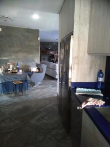 a kitchen with a table and a refrigerator in a room at Rural Villa Garcia Molina Baza in Baza