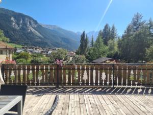 a wooden deck with a view of a mountain at Gîte Le Cembro 6 personnes in Termignon