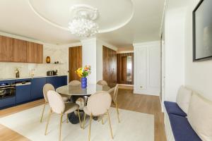 a kitchen and dining room with a table and chairs at Luxury 3 Bedroom & 3 Bathroom Apartment - Marais in Paris