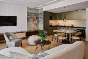 a living room and kitchen with a table and chairs at Carlton Cannes, a Regent Hotel in Cannes