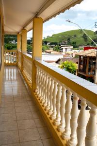 a balcony with white railings and a view at Respiro na Serra, casa no coração de Gonçalves in Gonçalves