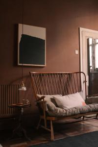 a chair in a room with a table and a lamp at Mid-Century Studio in London