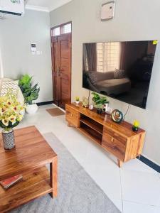 a living room with a large flat screen tv at kaya homes in Dar es Salaam