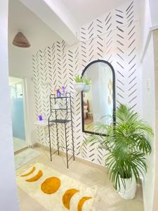 a bathroom with a mirror and a plant at MASKANI COSY APARTMENT - Nyali, Mombasa. in Mombasa