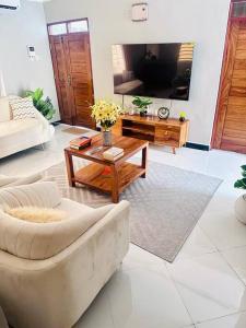 a living room with a couch and a coffee table at kaya homes in Dar es Salaam