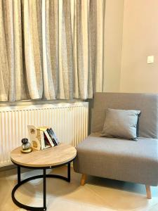 a room with a bed and a table with books at WITH LOVE forYOU in Volos