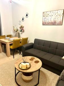 a living room with a couch and a table at WITH LOVE forYOU in Volos