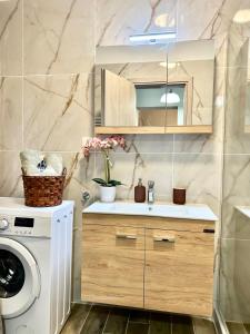 a bathroom with a sink and a washing machine at WITH LOVE forYOU in Volos