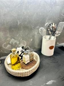 a tray with a bottle of oil and some kitchen utensils at WITH LOVE forYOU in Volos