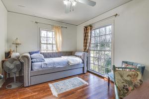 a living room with a couch and two windows at Quiet Fort Worth Home Less Than 1 Mi to TCU Campus! in Fort Worth