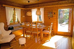 a wooden dining room with a table and chairs at Almliesl STEF-633 in Sankt Stefan im Lavanttal