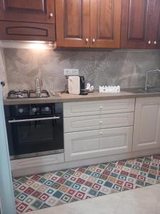 a kitchen with a stove and a counter top at MiraErice in Napola