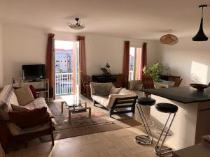a living room with a couch and a table at La terrasse des capucines in Sète