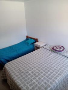 a bedroom with two beds and a blue comforter at Depto amoblado in Gualeguaychú