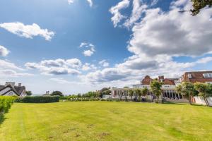 a large grassy yard in front of a building at Harbour Hotel & Spa Sidmouth in Sidmouth