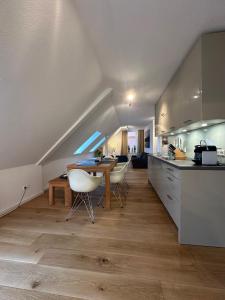 a kitchen and dining room with a table and chairs at Georg6 GEORG6 - Fewo 5 in Norderney +8 photos