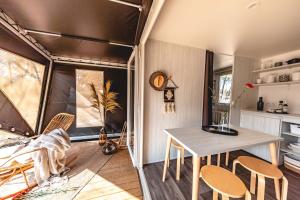 una habitación con mesa y sillas en una casa en Camping Villaggio Internazionale, en San Menaio