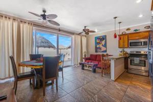 a kitchen and living room with a table and a dining room at Tai Condo 2 in Barra de Navidad